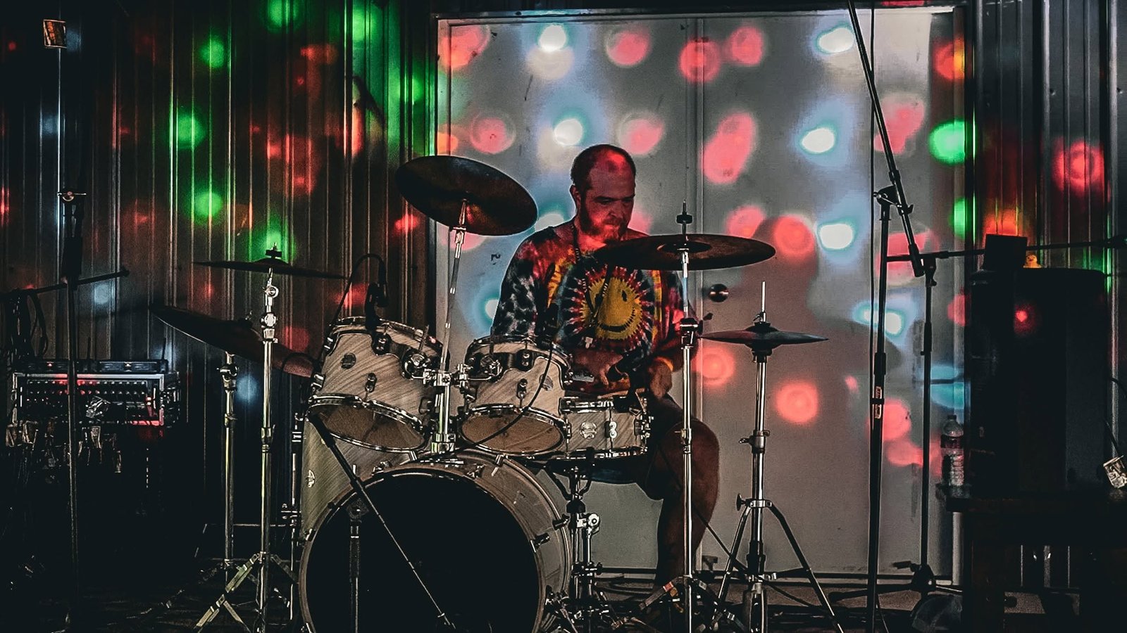 Marc Butts behind the drum kit in psychedelic light